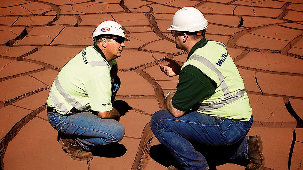 WesTech engineers talking on tailings bed