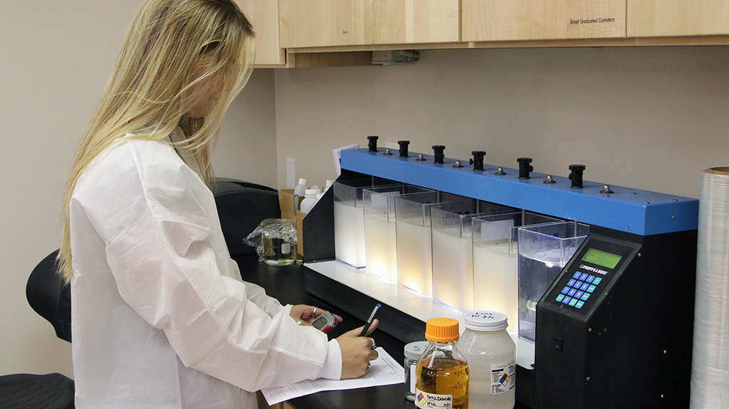 Lab tech Kayla running tests and recording results