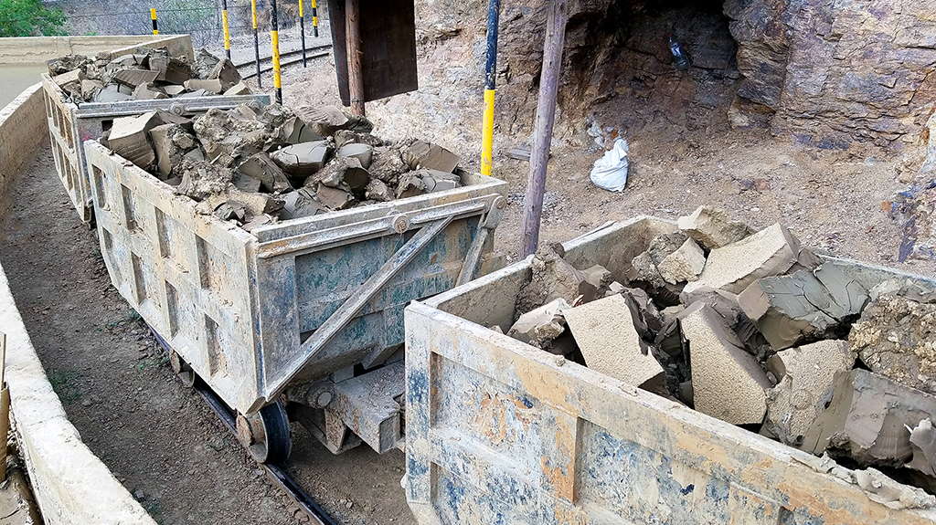 Mine carts on track loaded with rock