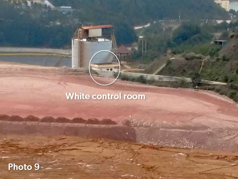 Photo 9 - Tailings storage area filled up after 5 years, white control room shown as reference