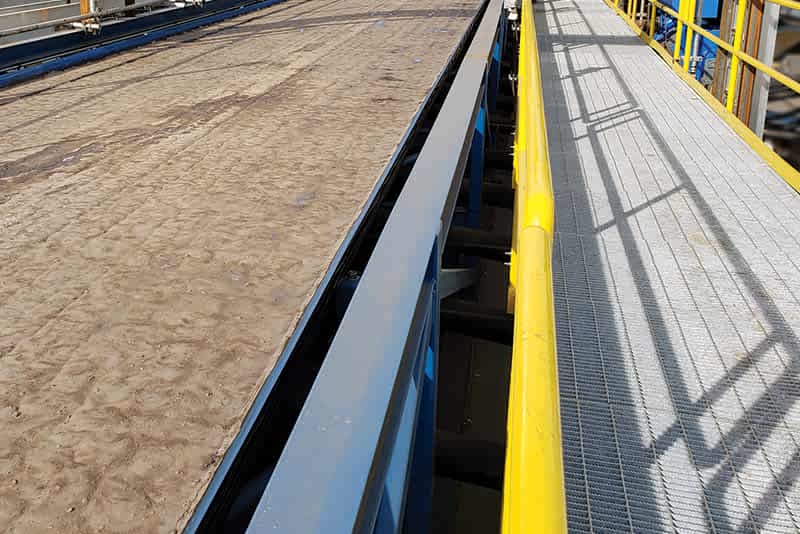 Close of of operating horizontal belt filter showing slurry on belt