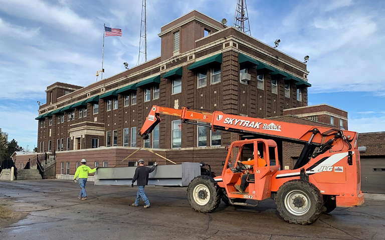 A crane moves an underdrain for retrofit of old filters