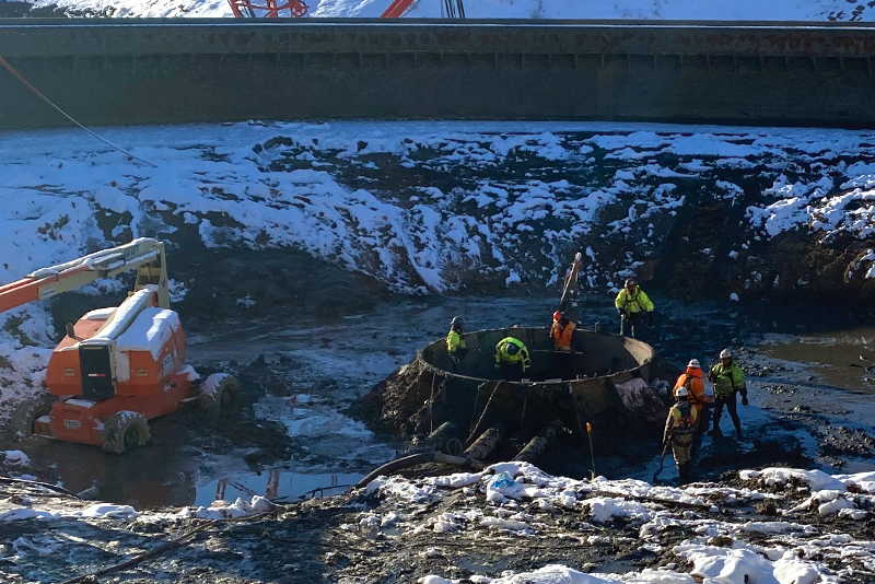 Workmen digging around thickener column base